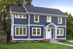 A two story home with blue siding. 