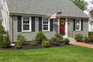 A one-story home with gray siding and roofing.